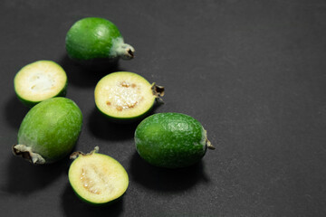 Feijoa fruits on black background. Tropical ripe feijoa fruits.