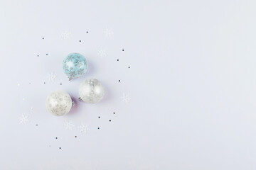 Fototapeta na wymiar Silver confetti and christmas balls on background. Flat lay, top , copy space, holiday background.