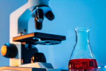 Medical vial with medication near microscope photo