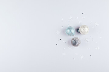 Silver confetti and christmas balls on background. Flat lay, top , copy space, holiday background.