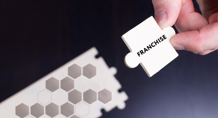 Business, Technology, Internet and network concept. Young businessman shows the word: Franchise