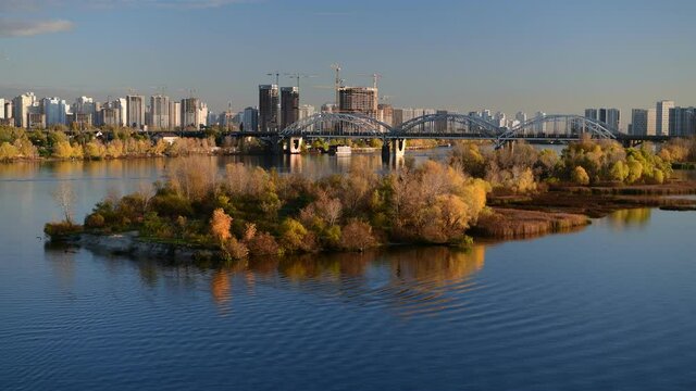 Nice evening panoramic view of Dnipro river with island Ostriv Malyy and bridge from Paton bridge in Kiev, Ukraine