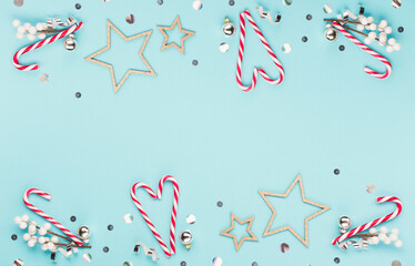 Christmas or winter holiday composition. Card with snowflakes and glitter stars on pastel blue background.