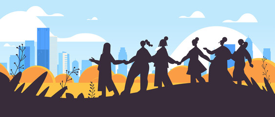 girls silhouettes standing together female empowerment movement women's community union of feminists concept cityscape background horizontal full length vector illustration