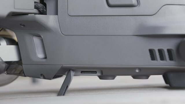 Close up of drone body on blurred background. Action. Grey plastic details of a professional small new quadcopter, equipment for the aerial shooting.