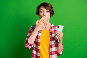 Portrait of attractive nervous person arm close mouth bad news checkered outfit isolated on green...