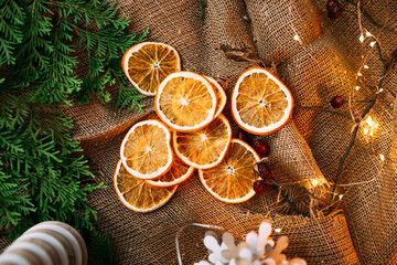 Dried orange slices on the sackcloth with garland
