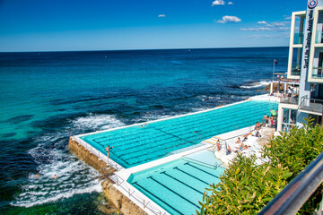 BONDI BEACH, AUSTRALIA - AUGUST 18, 2018: Tourists and locals enjoy Iceberg Pools on a wonderful...