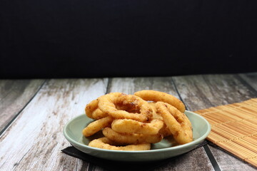 Onion ring, deep fried sliced fresh onion with flour on the plate. Famous snack and appetizer menu in Asia fast food. 