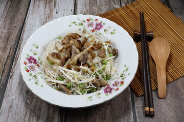 Rice noodle salad mixed with roasted pork, sliced string bean and fresh bean sprouts seasoning with pickled fish sauce ono the plate. Famous traditional appetizer menu in Asia restaurant.