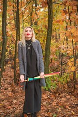 Blonde nice woman at autumn coat and colorful umbrella at park. Pretty plus size European lady