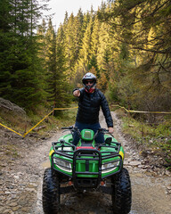 A man on a quad bike in the mountains.