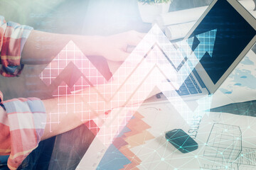 Growing arrows with businessman working on computer on background. Success concept. Double exposure.