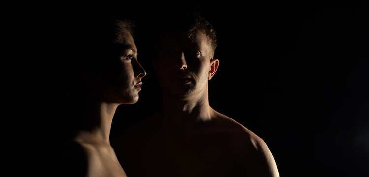 Young couple in love on black background. Couple in love. Photo. Dark. Photo. Sensual. Beauty. Light.

