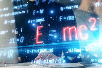 Science formula hologram with man working on computer on background. Education concept. Double exposure.