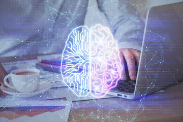 Businessman with computer background with brain theme hologram. Concept of brainstorm. Multi exposure.