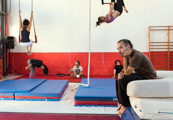 The students of the circus school rehearse with the trapezes