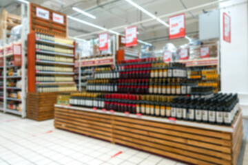 Blurred supermarket background. Selling alcohol in the supermarket.