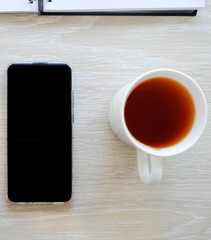 Fototapeta na wymiar Headphones, telephone and tea on the table.