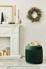 Stylish christmas composition at living room interior with white chimney, christmas tree and wreath, stars, gifts and decoration. Santa clause is coming. Template.