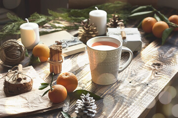 Chic cozy craft gift boxes and white christmas mug on wooden background. Natural aestetic. Zero waste, plastic free, trendy hand made gift package for Christmas.