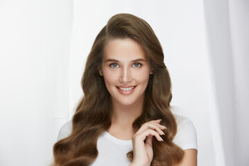 beautiful girl with volumed long curly hair