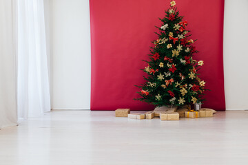 Christmas tree pine with gifts decor interior of the house new year