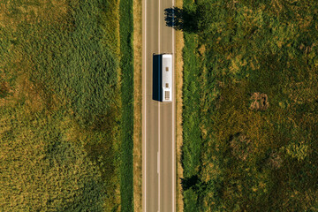 Aerial view of passenger bus on road through countryside