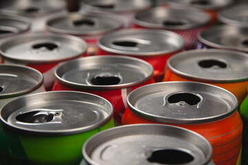 Top view of a lot of multi-color opened aluminium cans of beer or soda