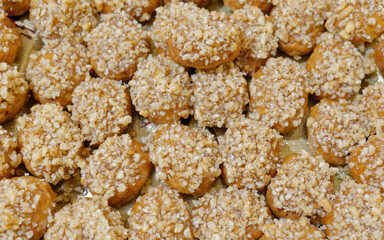 melomacarona, traditional Greek Christmas gourmet cookies with honey syrup and nuts, brown pattern background