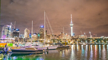 Fototapeta na wymiar AUCKLAND, NZ - AUGUST 26, 2018: Waterfront park and buildings at night