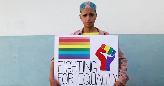 Gay girl looking serious in front of camera while holding lgbt banner - Fighting for equality concept - Slow Motion