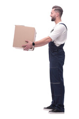 side view. smiling man passing a cardboard box