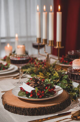 Christmas Eve table with candles and decorations.