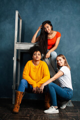 diverse nation girls group, teenage friends company cheerful having fun, happy smiling, cute posing on blue background, lifestyle people concept