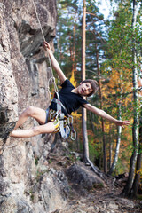 cute teen kid climbing on rock with insurance, lifestyle sport people concept