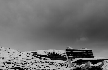 Bench on the snow on winter, black and white