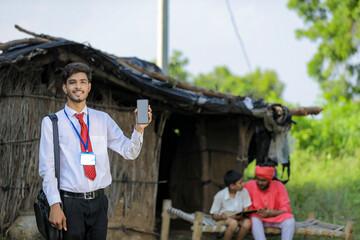 Young indian bank officer showing mobile screen with farmer