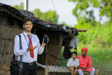 Young indian bank officer showing mobile screen with farmer