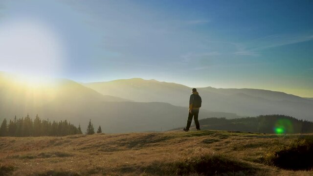A man travels in the mountains. Beautiful nature of the Carpathian mountains. The concept of travel and active lifestyle. 4K