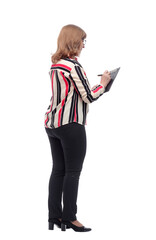 smiling casual woman writing something to the clipboard.