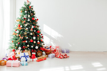 Fototapeta na wymiar Christmas tree with gifts decor garland new year interior