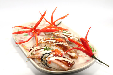 Healthy Home Cooking - Grilled pork sushi placed on a white plate, is a Japanese style Thai food on a white background and is sold at Thailand and every festival.