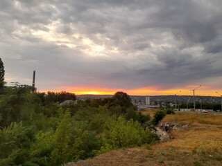 sunset with clouds on the background of the city