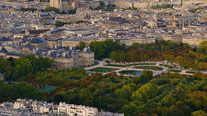 Beautiful aerial panorama view of famous park area Jardin du Luxembourg with historic Luxembourg Palace and discolored trees in early autumn in the dense city center of Paris, France.