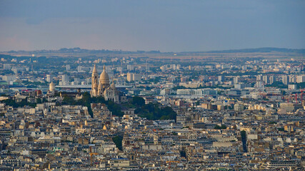 Closeup aerial panorama view of Montmartre hill in the north of the historic center of Paris, France with famous white colored cathedral Sacre-Coeur in the evening light.