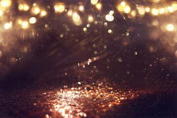 Naklejka premium background of abstract gold and black glitter lights. defocused