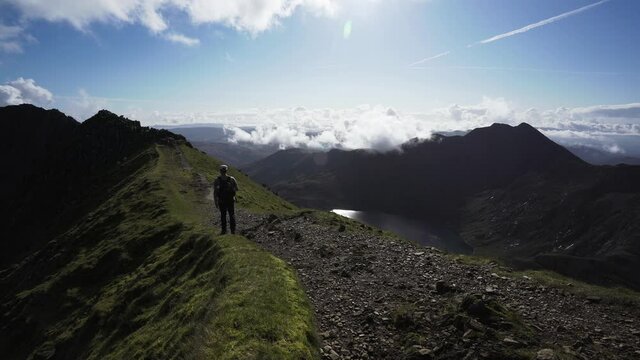 A man hiking a gorgeous mountain ridge in North Wales UK