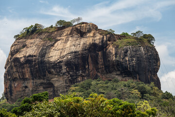 Fototapeta na wymiar Sigiriya Rock Sri Lanka photographed from rear above forest with blue sky