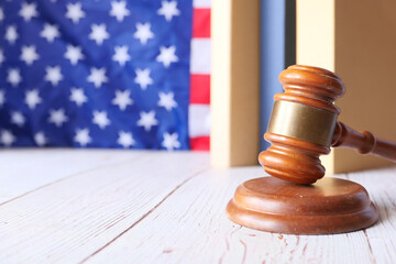 Closeup of gavel and book against american flag 